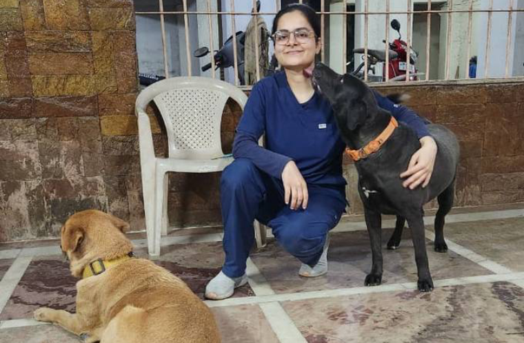 Dr. Naina with dogs during a home visit